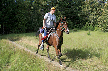 Man riding a horse in running outfit