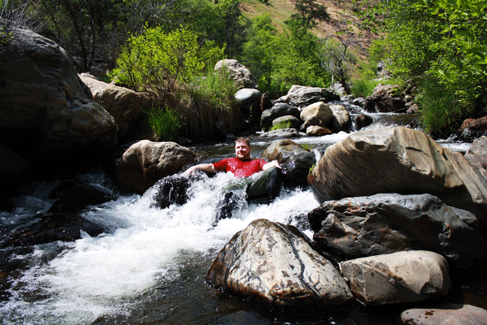 A rafter enjoys some hydrotherapy during a pit-stop hike up the North Fork Tuolumne (OARS).