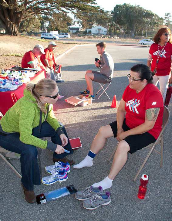 A Superfeet representative fits a veteran with shoe insoles at a Tuesday evening workout.
