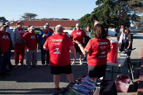 Russ and Tina Coillot, co-owners of Fleet Feet Aptos and Monterey, address the veterans before a Tuesday evening workout.