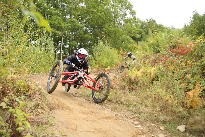 High Fives athlete Lindsey Runkel rides her X-plorer III downhill mountain bike at Thunder Mountain. Lindsey received a board approved Empowerment grant in 2015 to be able to return to the sport she loves. Photo: Lindsay Runkel.