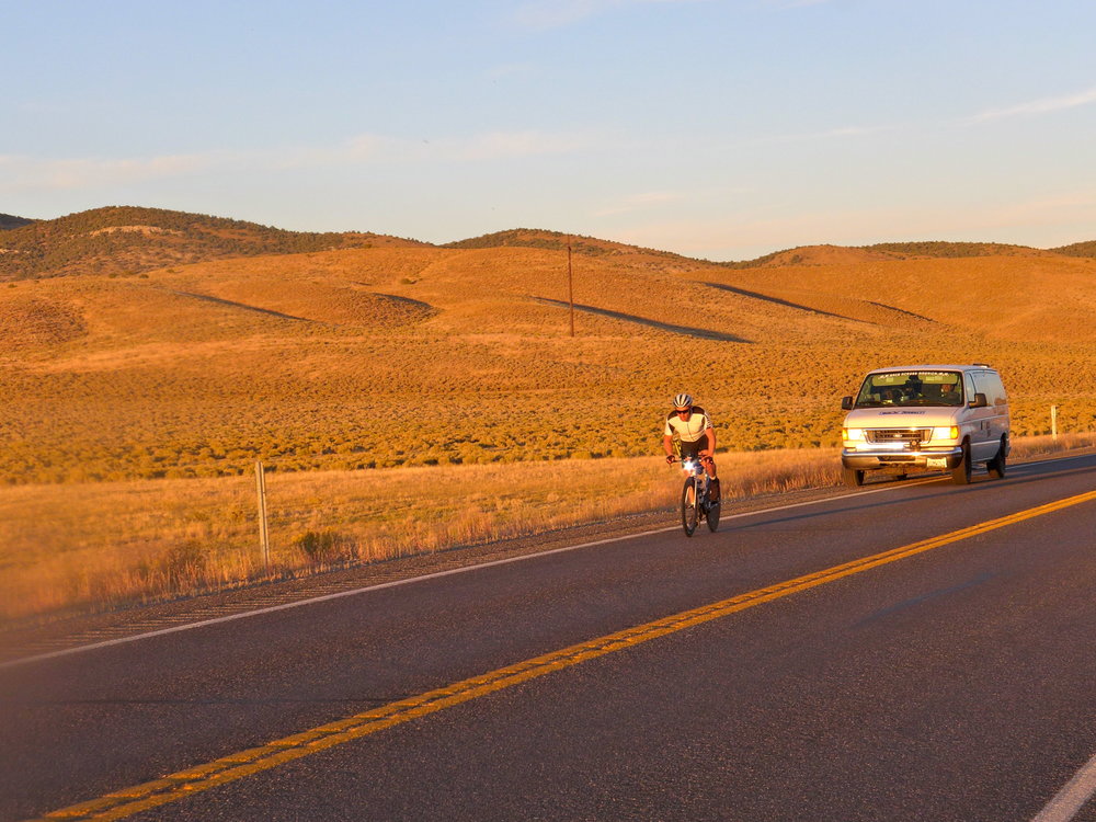 Photo of cyclist with a support vehicle 