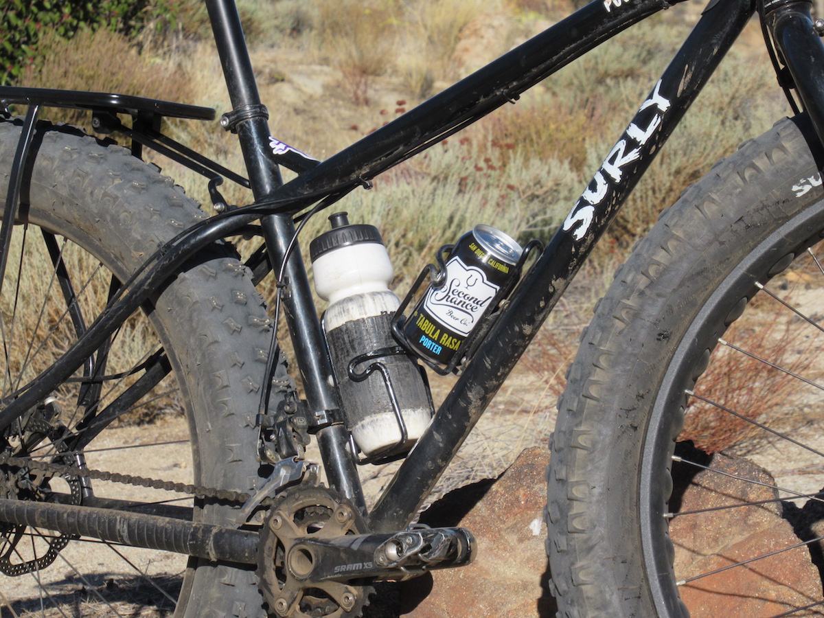 Photo of bike frame with a water bottle and a can of beer