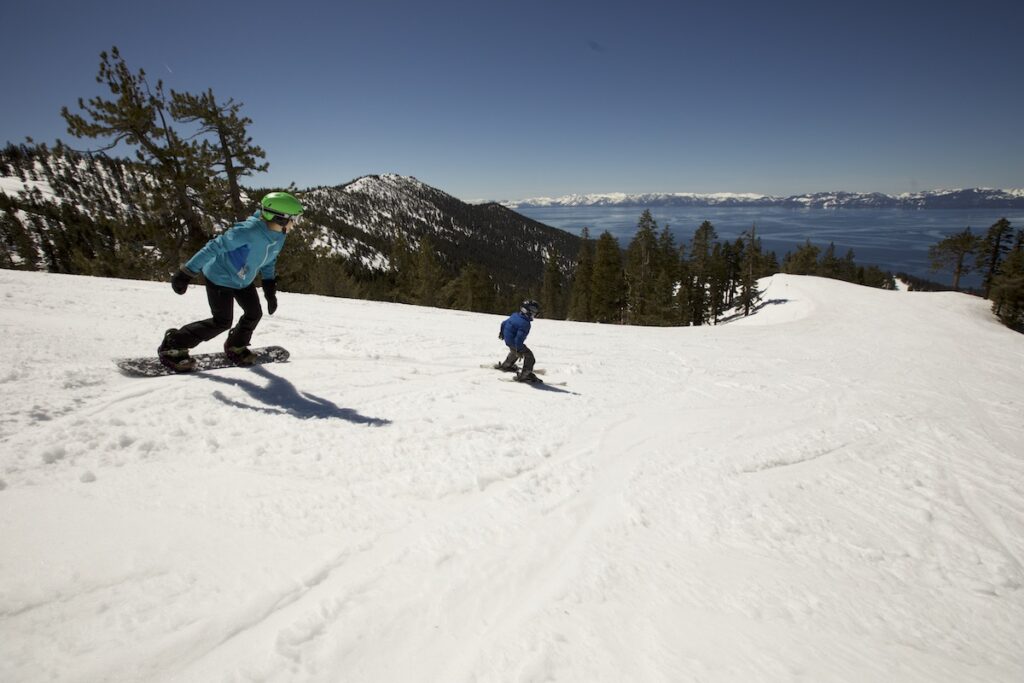 Photo of a mother and son boarding and skiing at Diamond Peak