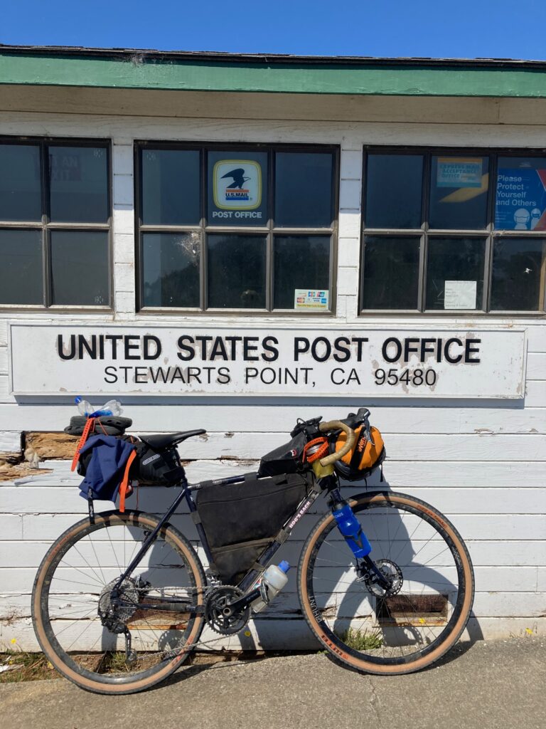 Refilling water at the Stewarts Point Post Office. Full bike pack