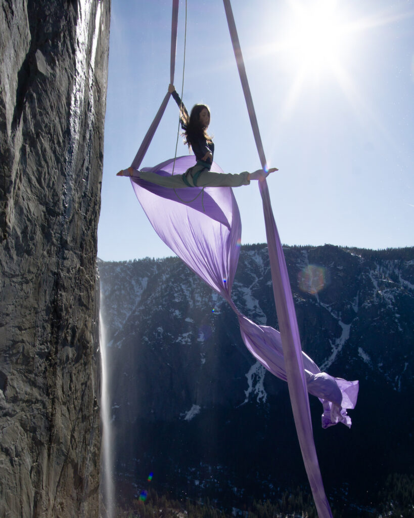 Priscilla Mewborne silks during a winter ascent of El Capitan with Horsetail Falls in the background