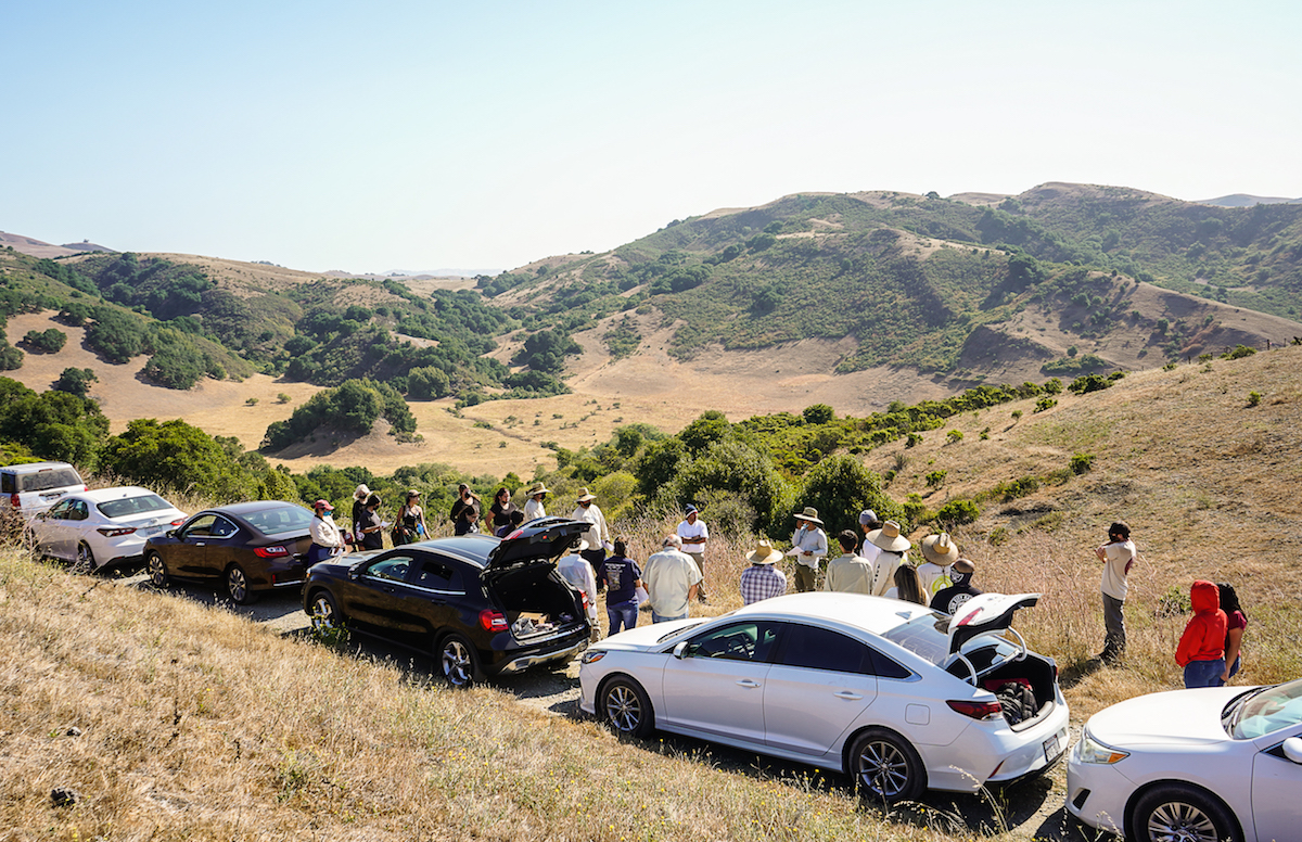 Photo of Amah Mutsun tribal members gather earlier this year on a ridge overlooking a portion of the Juristac tribal cultural landscape in southeast Santa Clara County