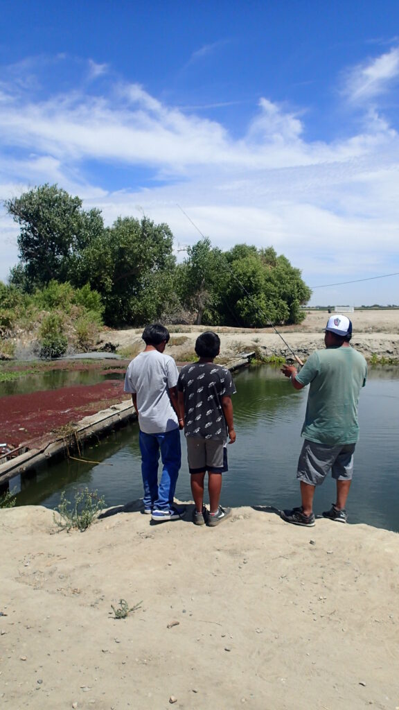 Father and his two sons fishing out of Tulare Lake.