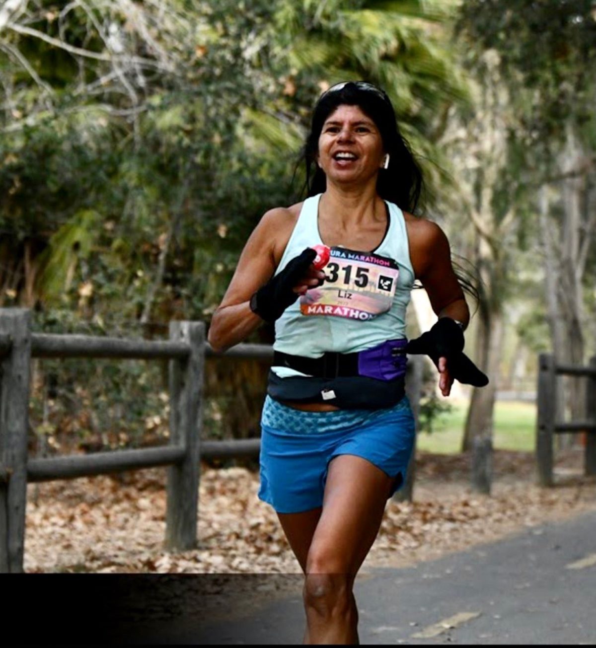 Liz Guerrini manages a smile while racing in the Ventura Half Marathon.