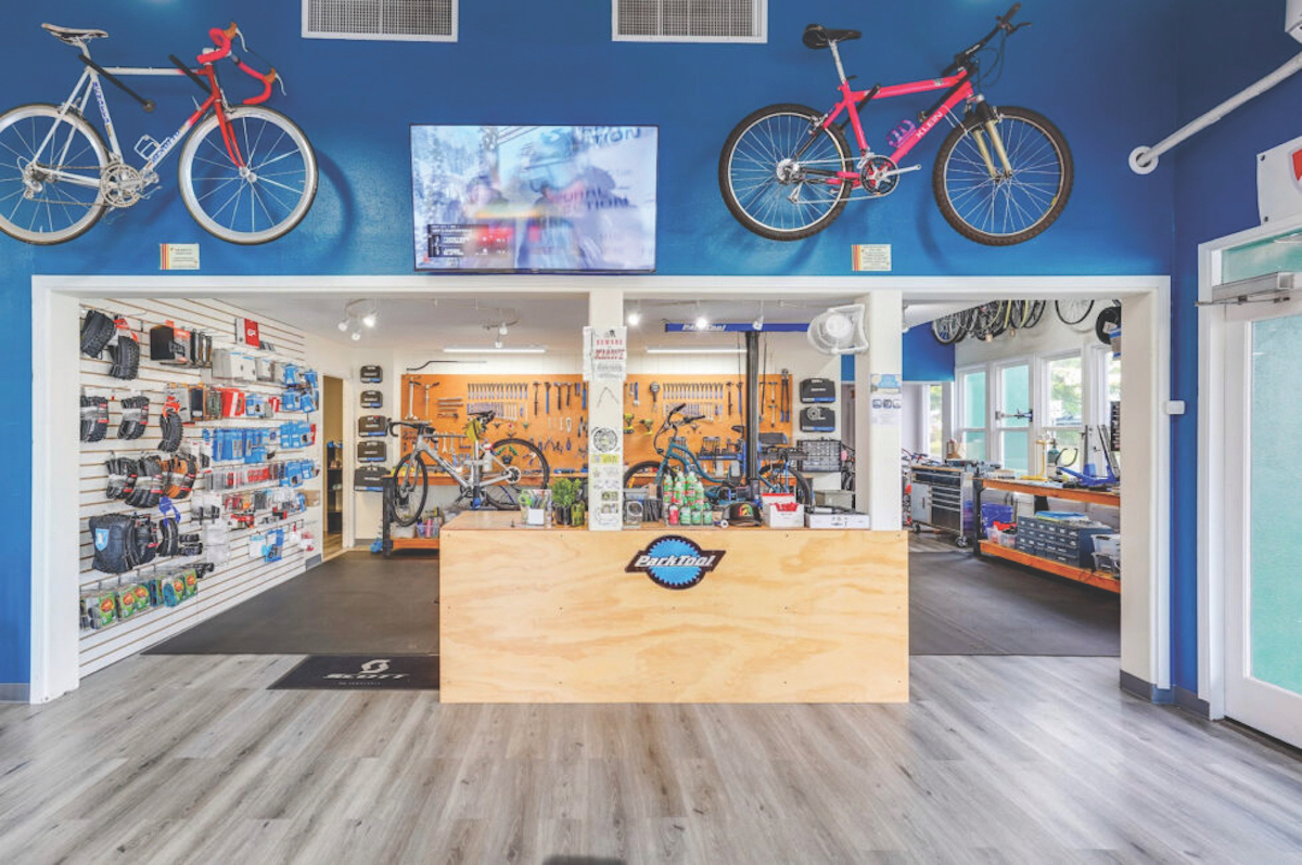 Photo of inside of Maui Sunriders Bike Shop with bright blue walls and bikes and accessories. 