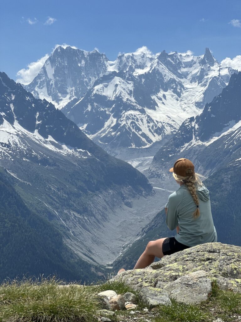 Hannah Wanish sits near mountains.