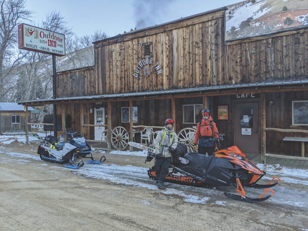 Photographer and author standing outside of a lodge preparing their sleds.