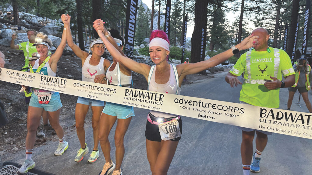 Photo of Ashley Paulson and her support crew crossing the finish line.