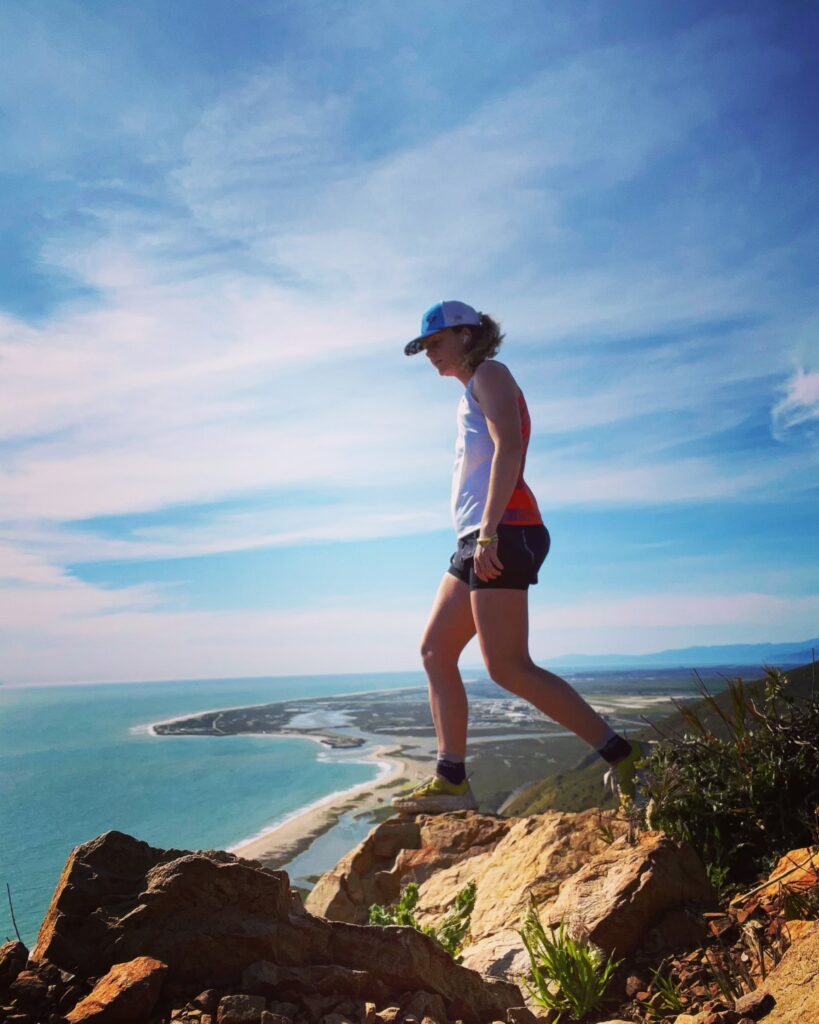 Alyssa overlooking the coast of California on a rocky trail run